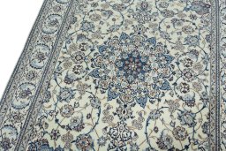 Backside of handmade New Nain rug showing knot structure and weave density