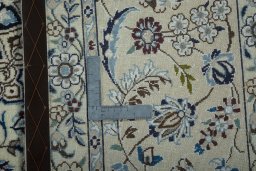 Backside of handmade 2000s Nain rug showing knot structure and weave density