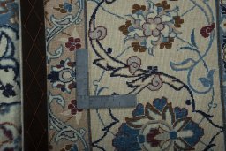 Backside of handmade 2000s Nain rug showing knot structure and weave density