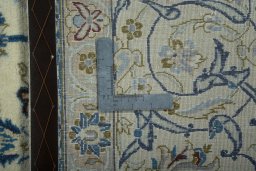 Backside of handmade 2000s Nain rug showing knot structure and weave density