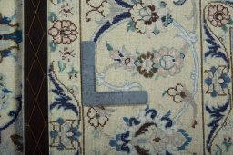 Backside of handmade New Nain rug showing knot structure and weave density