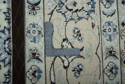Backside of handmade New Nain rug showing knot structure and weave density