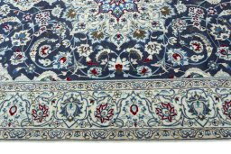 Corner detail of 2000s Nain rug showing border pattern and Wool pile