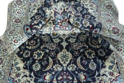 Surface texture of 2000s Nain rug with natural Wool and intricate pattern