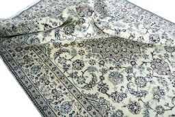 Surface texture of 2000s Nain rug with natural Wool and intricate pattern