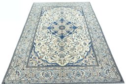 Surface texture of 2000s Nain rug with natural Wool and intricate pattern