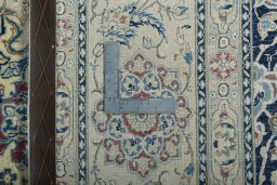 Backside of handmade 1970s Nain rug showing knot structure and weave density