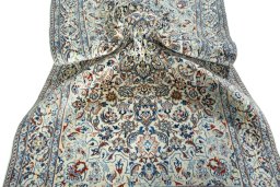 Surface texture of 2000s Nain rug with natural Wool and intricate pattern