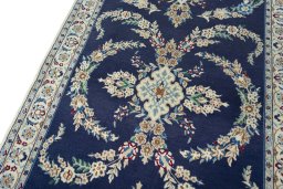 Backside of handmade 2000s Nain rug showing knot structure and weave density