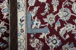 Backside of handmade New Nain rug showing knot structure and weave density