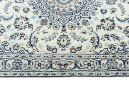 Corner detail of 2000s Nain rug showing border pattern and Wool pile