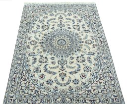 Surface texture of 2000s Nain rug with natural Wool and intricate pattern