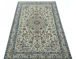 Surface texture of 2000s Nain rug with natural Wool and intricate pattern