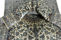 Surface texture of 2000s Nain rug with natural Wool and intricate pattern