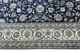 Corner detail of 2000s Nain rug showing border pattern and Wool pile
