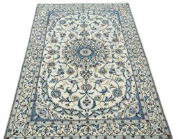 Surface texture of 2000s Nain rug with natural Wool and intricate pattern