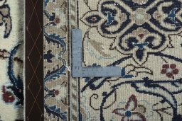 Backside of handmade 2000s Nain rug showing knot structure and weave density