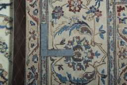 Backside of handmade 2000s Nain rug showing knot structure and weave density