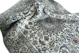 Surface texture of 2000s Nain rug with natural Wool and intricate pattern