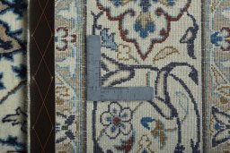 Backside of handmade 2000s Nain rug showing knot structure and weave density