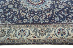 Corner detail of 2000s Nain rug showing border pattern and Wool pile