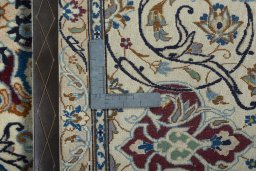 Backside of handmade 2000s Nain rug showing knot structure and weave density