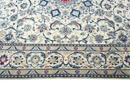 Corner detail of 2000s Nain rug showing border pattern and Wool pile