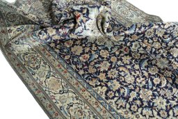 Surface texture of 1970s Nain rug with natural Wool and intricate pattern