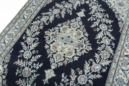 Backside of handmade New Nain rug showing knot structure and weave density