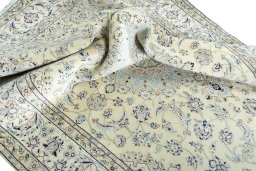 Surface texture of 2000s Nain rug with natural Wool and intricate pattern