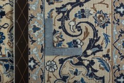 Backside of handmade 2000s Nain rug showing knot structure and weave density