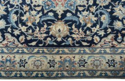 Corner detail of 2000s Nain rug showing border pattern and Wool pile