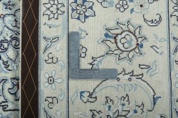 Backside of handmade New Nain rug showing knot structure and weave density