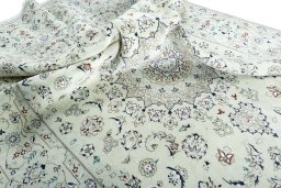 Surface texture of 2000s Nain rug with natural Wool and intricate pattern
