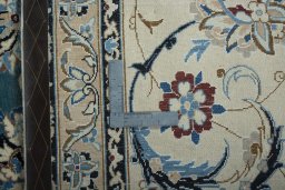 Backside of handmade 2000s Nain rug showing knot structure and weave density