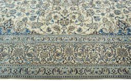 Corner detail of 2000s Nain rug showing border pattern and Wool pile