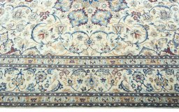 Corner detail of 2000s Nain rug showing border pattern and Wool pile