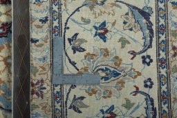 Backside of handmade 2000s Nain rug showing knot structure and weave density