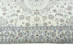 Corner detail of 2000s Nain rug showing border pattern and Wool pile