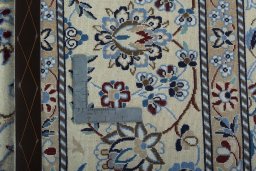 Backside of handmade 2000s Nain rug showing knot structure and weave density