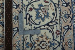 Backside of handmade New Nain rug showing knot structure and weave density