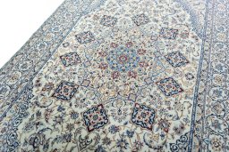 Backside of handmade New Nain rug showing knot structure and weave density