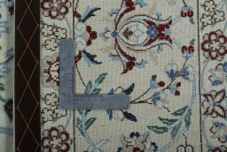 Backside of handmade New Nain rug showing knot structure and weave density