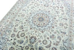 Backside of handmade New Nain rug showing knot structure and weave density