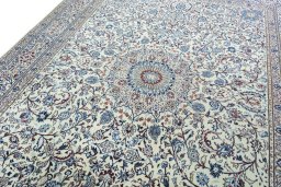 Backside of handmade New Nain rug showing knot structure and weave density