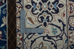 Backside of handmade 2000s Nain rug showing knot structure and weave density