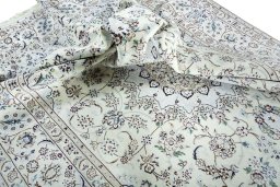 Surface texture of 2000s Nain rug with natural Wool and intricate pattern