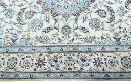 Corner detail of 2000s Nain rug showing border pattern and Wool pile