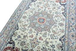 Backside of handmade New Nain rug showing knot structure and weave density