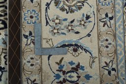 Backside of handmade New Nain rug showing knot structure and weave density
